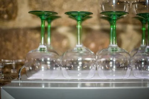 View with empty gin transparent glass cups stand upside down in bar Stock Photos