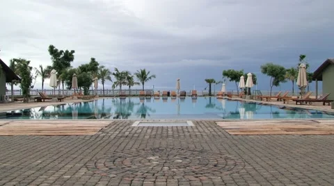 View to the empty hotel swimming pool at sunrise in Trincomalee, Sri Lanka. Stock Footage 62317936
