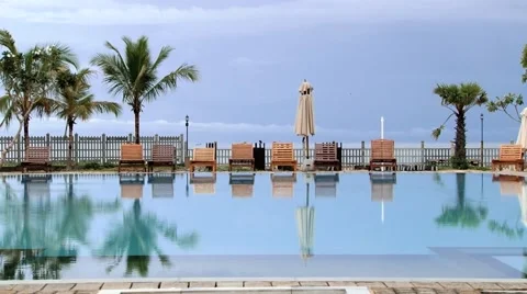 View to the empty hotel swimming pool at sunrise in Trincomalee, Sri Lanka. Stock Footage 62317963