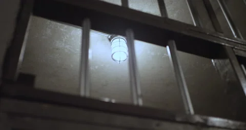 View of empty jail cell in prison - light hanging on the ceiling Stockbeeldmateriaal 137824176