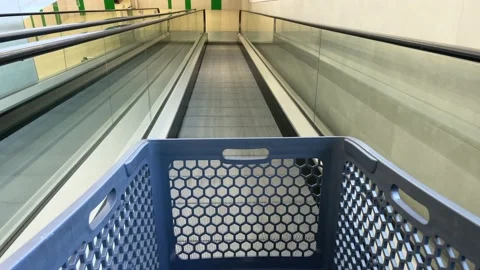 View from an empty market trolley on a mechanical walkway to the supermarket 動画素材 201855732