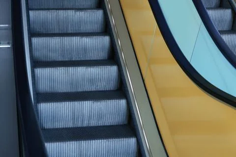 View on empty parallel escalators with yellow balustrades, closeup Stock Photos