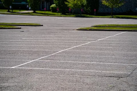 View of empty parking spaces in large parking lot Stock Photos
