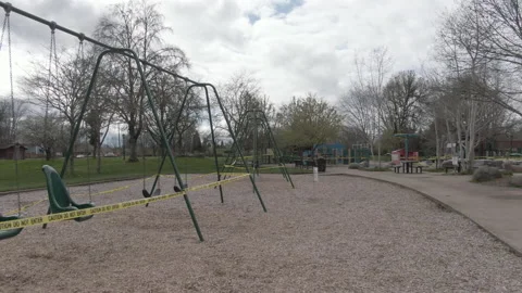 View of Empty Playground with Caution Tape During Virus Outbreak on Overcast Day 스톡 동영상 208763114