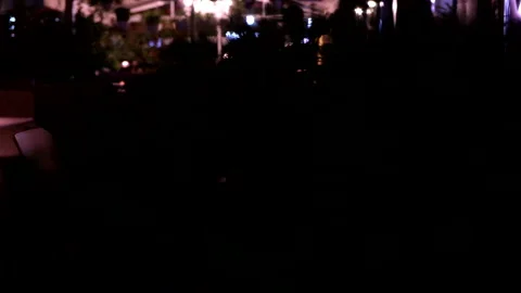 View of empty restaurant table outdoors with lamp in the middle Stock Footage 233498363