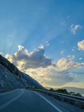 View of an empty road between mountains leading to the Greece Stock Photos