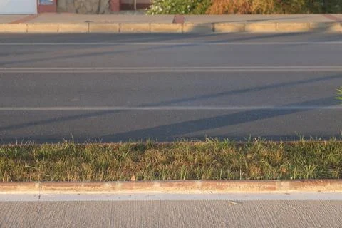 View of the empty road scene, highway in the city, trees and bushes, curb s.. Stock Photos