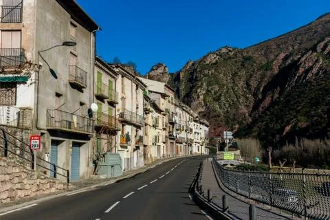 The view of an empty road through a Spanish town in the Pyrenees mountains wi Stock Photos