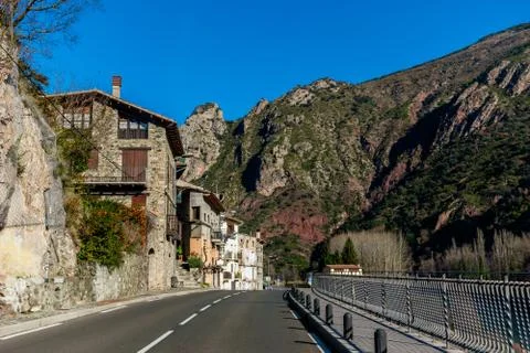 The view of an empty road through a Spanish town in the Pyrenees mountains wi Stock Photos