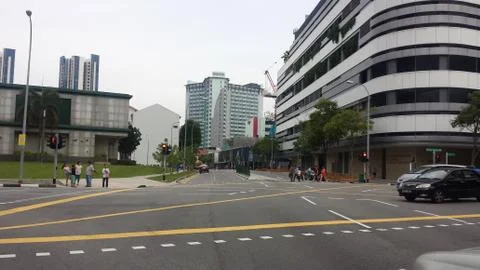 View of empty road at traffic light at Singapore with background of modern bu Stock Photos