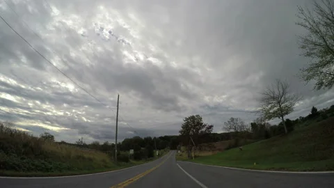 View of an empty rural road with power lines Stock Footage 155761424