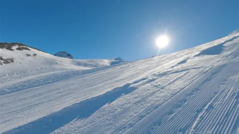 View of empty ski piste in Kaprun winter resort on sunny day Stock Footage 307706247
