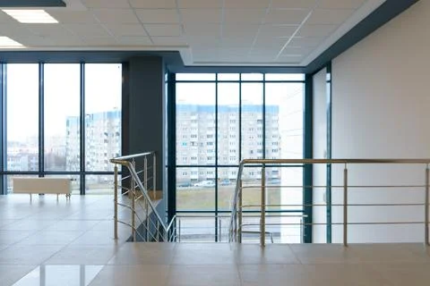 View of the empty spacious hall with large panoramic windows. Modern interior Stock Photos