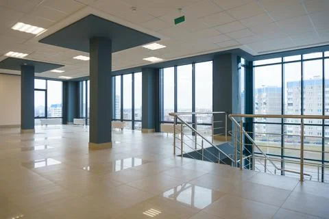 View of the empty spacious hall with large panoramic windows. Modern interior Stock Photos