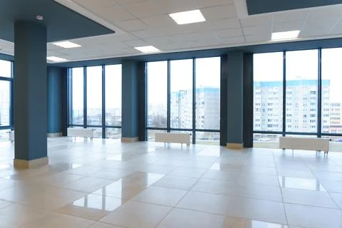 View of the empty spacious hall with large panoramic windows. Modern interior Stock Photos
