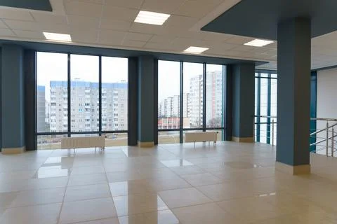 View of the empty spacious hall with large panoramic windows. Modern interior Stock Photos