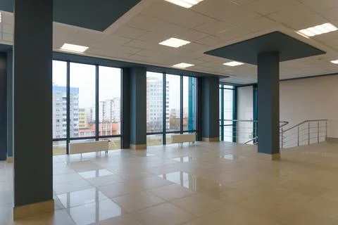 View of the empty spacious hall with large panoramic windows. Modern interior Stock Photos