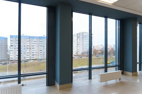 View of the empty spacious hall with large panoramic windows. Modern interior Stock Photos