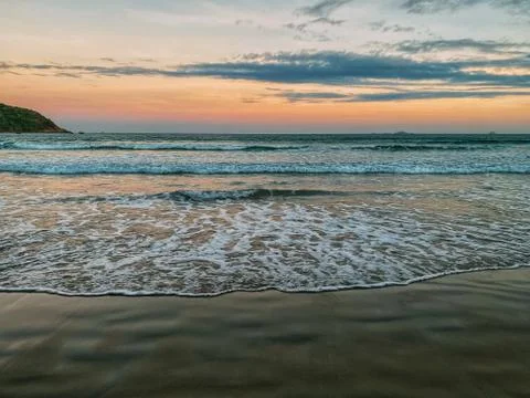 View of an empty tropical beach at sunset.  dramatic lighting Stock Photos