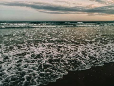 View of an empty tropical beach at sunset.  dramatic lighting Stock Photos