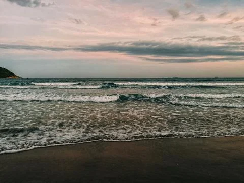 View of an empty tropical beach at sunset.  dramatic lighting Stock Photos