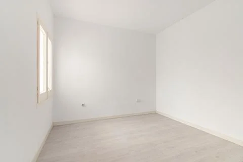 View of an empty white bright room with window without furniture after painting Фото