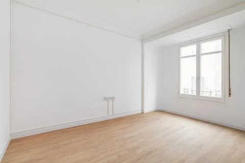 View of an empty white bright room with window without furniture after painting Stock Photos