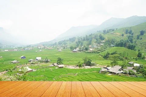 The view of the empty wooden table with the upper farmer village and the mist Stock Photos