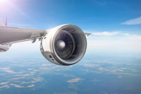 View of the engine on the wing of the aircraft during the flight in the sky Stock Photos