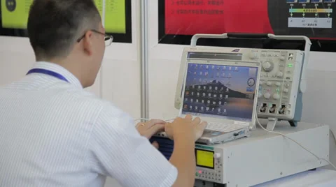 View of engineer using a notebook PC with instrument Stock Footage 38012380