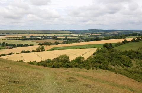 View of English countryside with patchwork fields and rolling hills. Stock Photos