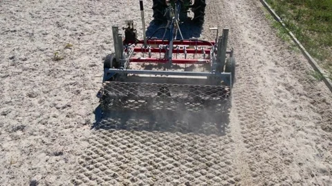 View of an equestrian implement mixing and smoothing the floor of the Stock Footage 239399159