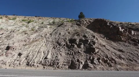 View of Eroding hillside next to road Stock Footage 42041714