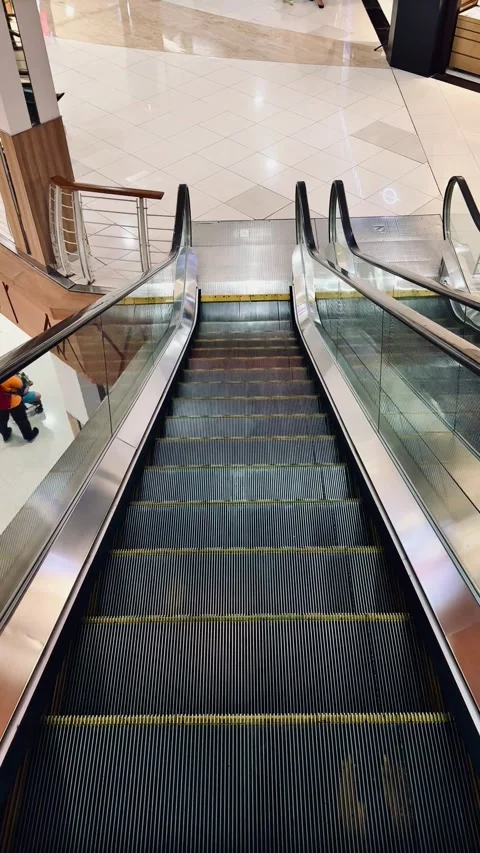 View from an escalator going down in mall. Stock Footage 290492227
