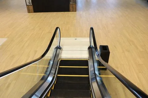 View of an Escalator in a Modern Building Featuring Beautiful Wooden Flooring Stock Photos