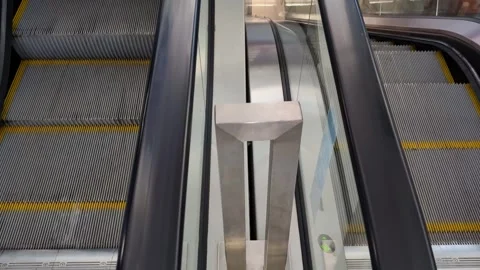 View of escalator steps and side panels in a modern shopping mall during busy af Stock Footage 311364702