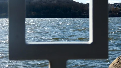 View of the evening city pond through the fence Stock Footage 105366328