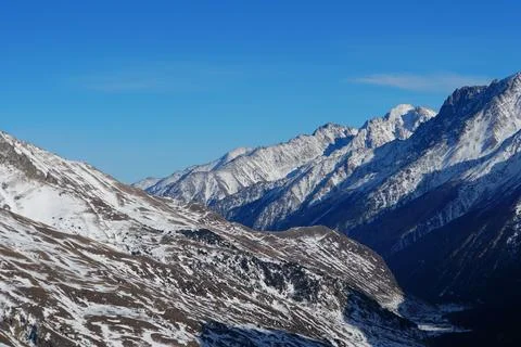 View of the evening mountain peaks with a cloud in the Caucasus Stock Photos