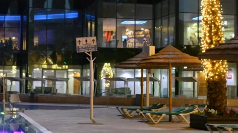 View on evening pool yard in luxury hotel. low lights 스톡 동영상 163079425