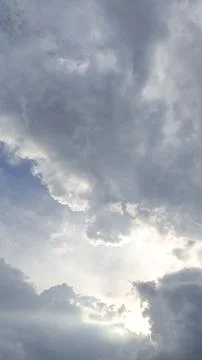 The view of the evening sky, the sun covered with white and black clouds. Stock Photos