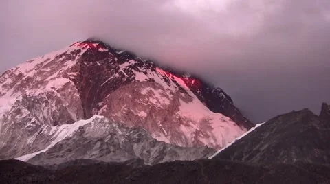 View of Everest hiding in the clouds at sunset. Himalayas. Nepal. Stock Footage 43743007