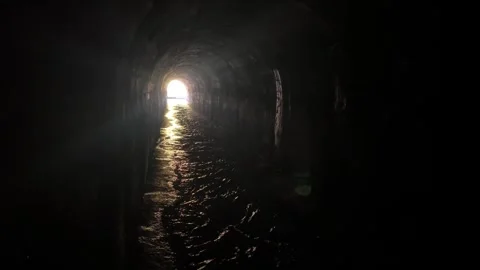 A view of the exit from the dark tunnel where the water flows. Stock Footage 273192428