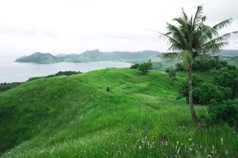 A view of the expanse of green hills, wide there is much white thatch. Backgr Stock Photos