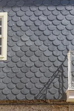 View of an external waterproof coating wall building with slate-shaped fish Stock Photos