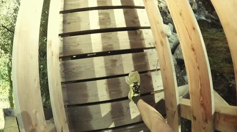 View from eye level with a man  wearing sneakers passing the bridge. Soft colors 스톡 동영상 53920875