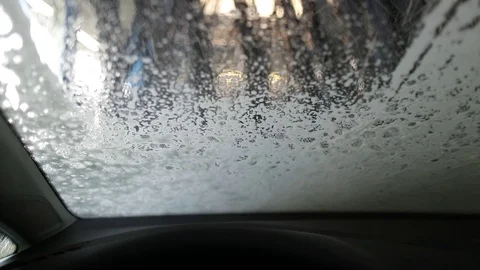 View f rom the cabin through the windshield of the car in the car wash Stock Footage 129709614