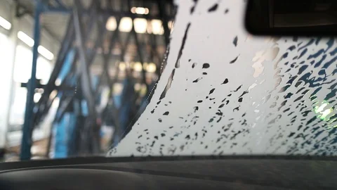 View f rom the cabin through the windshield of the car in the car wash Stock Footage 129709648