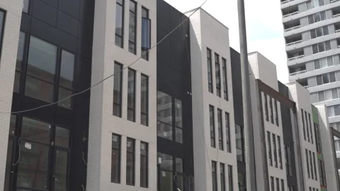View of the facade of a newly built modern multi-storey residential building. Stock Footage 221148726