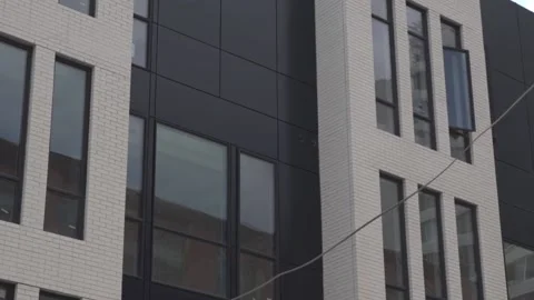 View of the facade of a newly built modern multi-storey residential building. Stock Footage 221148732