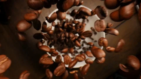 View of falling coffee beans into a bowl cup. Видео 309358016